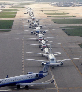 Picture of jets lined up on an O'Hare runway waiting to take off.